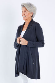 Model Elise wearing size S of the Living Large Merino Swing Cardi in colour Thunder (Grey), from the front, cropped image