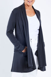 Model Elise wearing size S of the Living Large Merino Swing Cardi in colour Thunder (Grey), from the front, cropped image