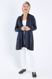 Model Elise wearing size S of the Living Large Merino Swing Cardi in colour Thunder (Grey), from the front, showing the whole outfit