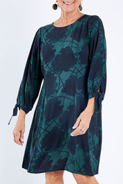 Model Elise wearing size 10 of the All Tied Up Dress in colour Slatefrond (Black), from the front, cropped image