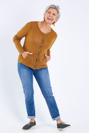 Model Elise wearing size S of the Stitched Up Cardi in colour Teak, from the front, showing the whole outfit