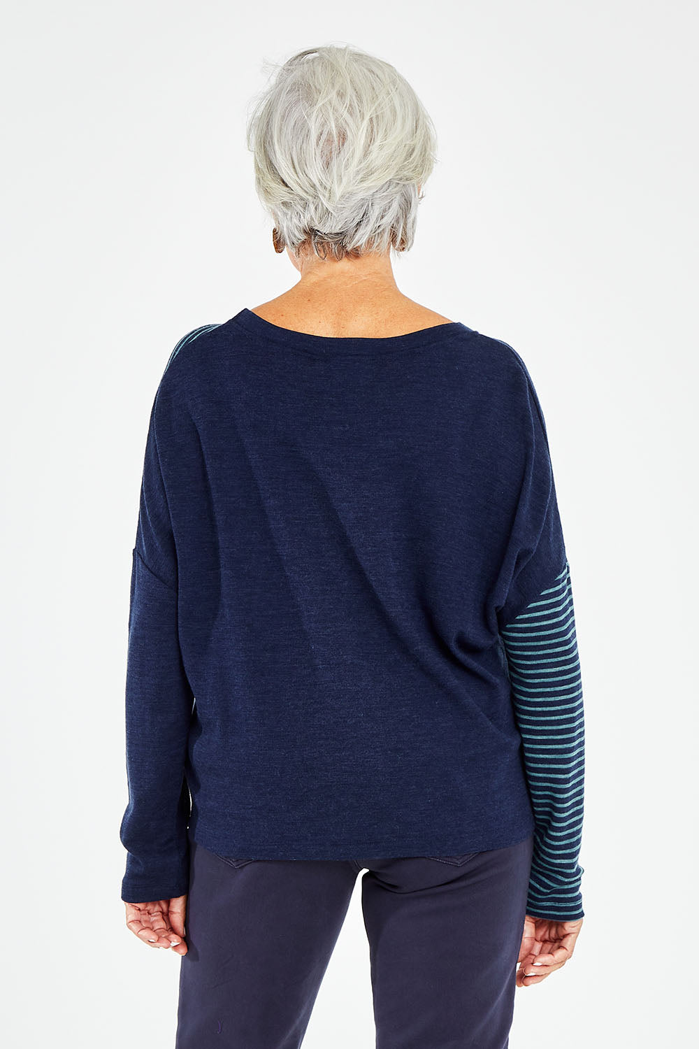 Model Elise wearing size S of the Two Times The Fun Merino Sweater in colour Navyspear (Blue), from the back