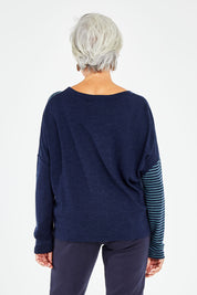 Model Elise wearing size S of the Two Times The Fun Merino Sweater in colour Navyspear (Blue), from the back