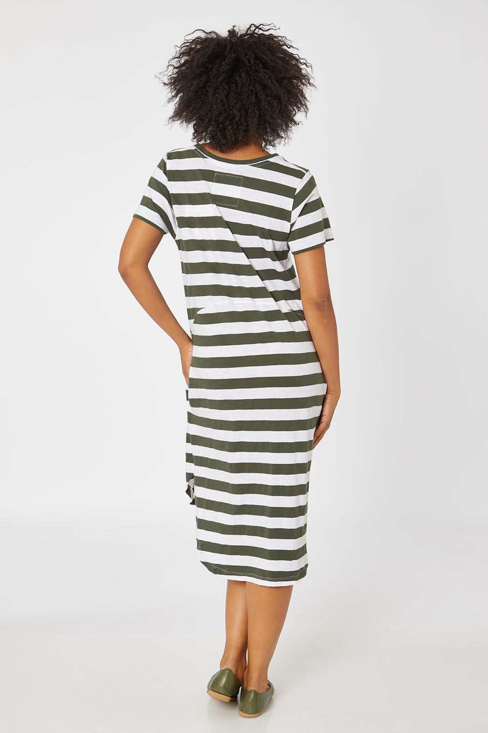 Model Olivia wearing size 10 of the Elements Bayley Dress in colour Khakstripe (White), from the back