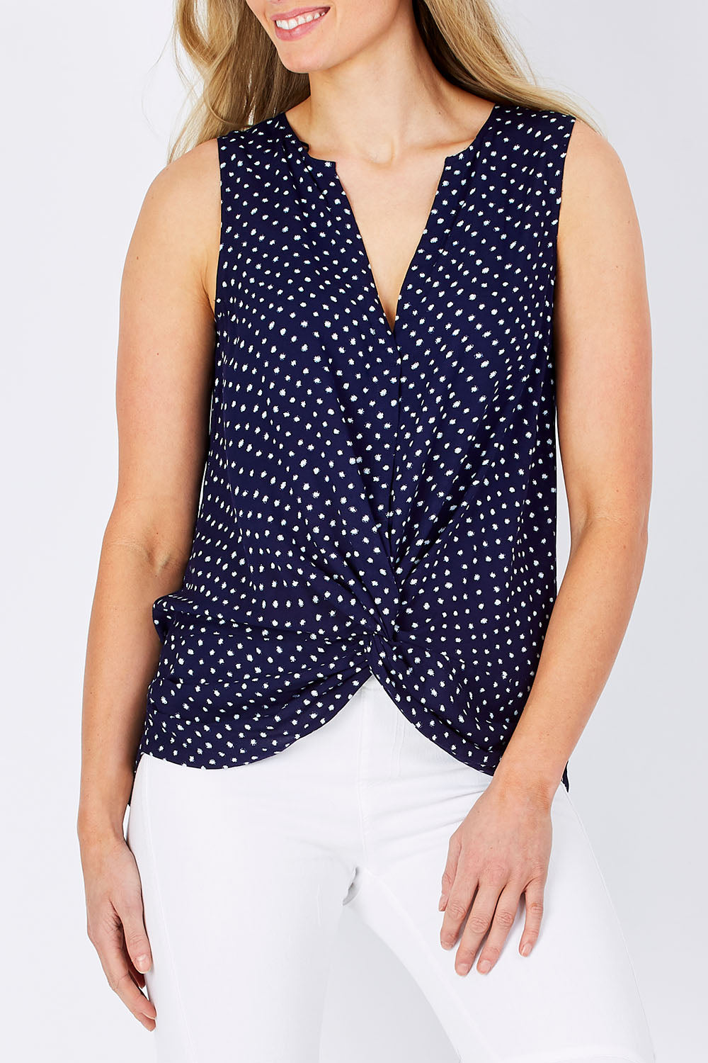 Model Maddy wearing size 10 of the Martinike Sleeveless Top in colour NavyPolka (Blue), from the front, cropped image