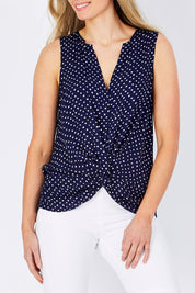 Model Maddy wearing size 10 of the Martinike Sleeveless Top in colour NavyPolka (Blue), from the front, cropped image