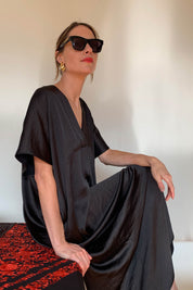 A model wearing the Before Midnight Dress in colour Black (Black), from the front, showing the whole outfit