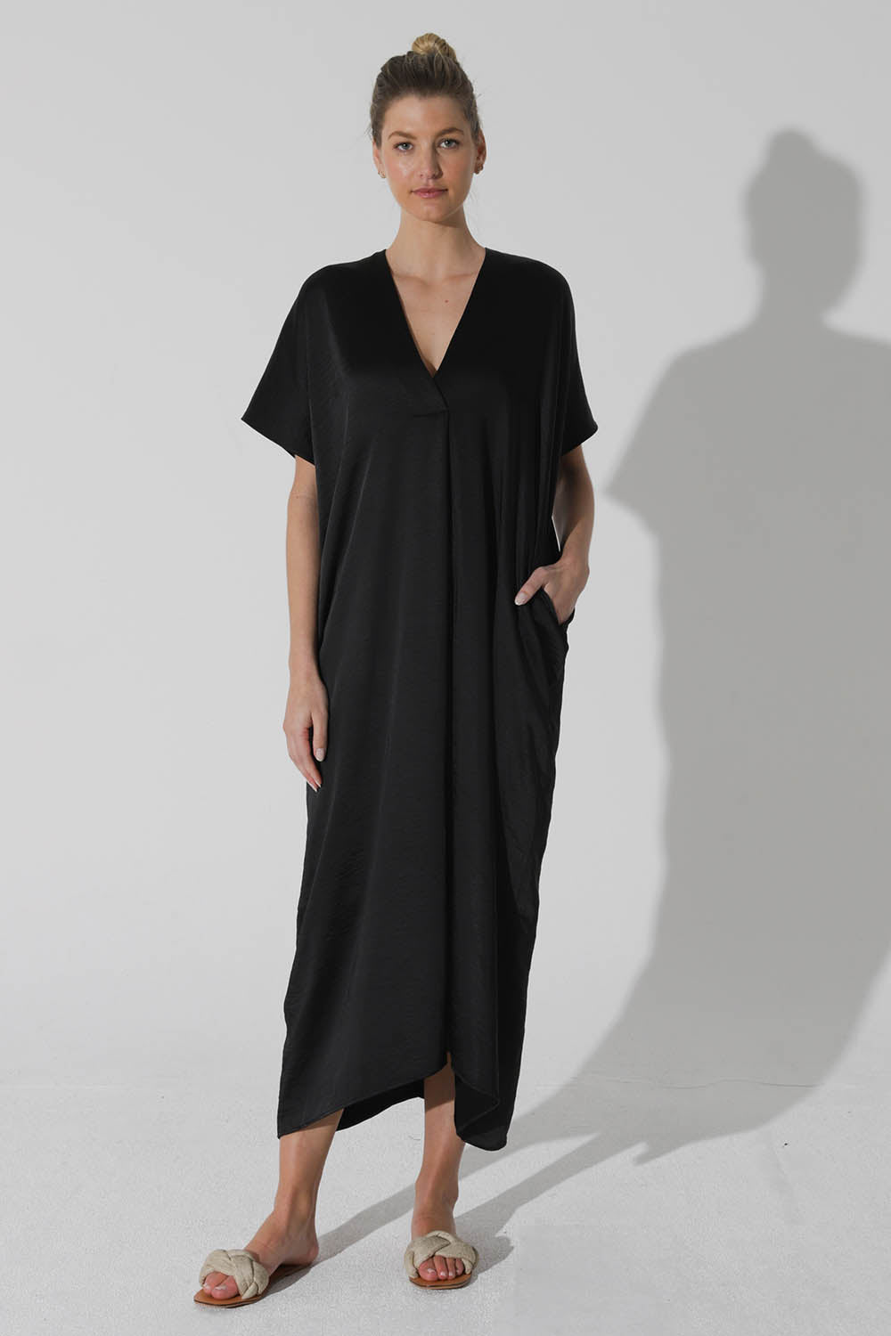 A model wearing the Before Midnight Dress in colour Black (Black), from the front, showing the whole outfit