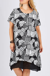 Model Ljubenka wearing size 18 of the Patterned Dress in colour BlackWhite (Black), from the front, cropped image