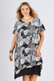 Model Ljubenka wearing size 18 of the Patterned Dress in colour BlackWhite (Black), from the front, cropped image