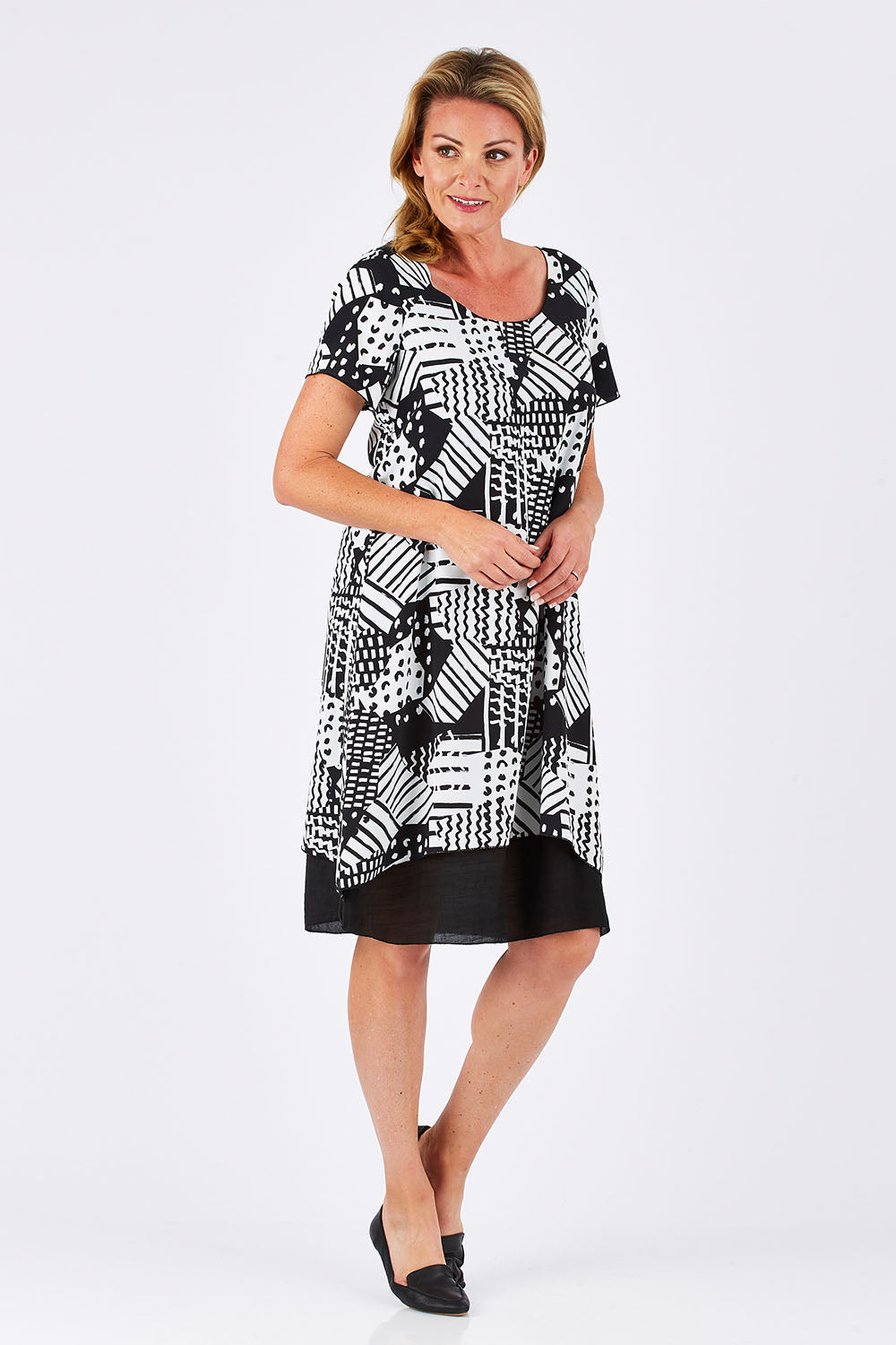 Model Louise wearing size 10 of the Patterned Dress in colour BlackWhite (Black), from the front, showing the whole outfit