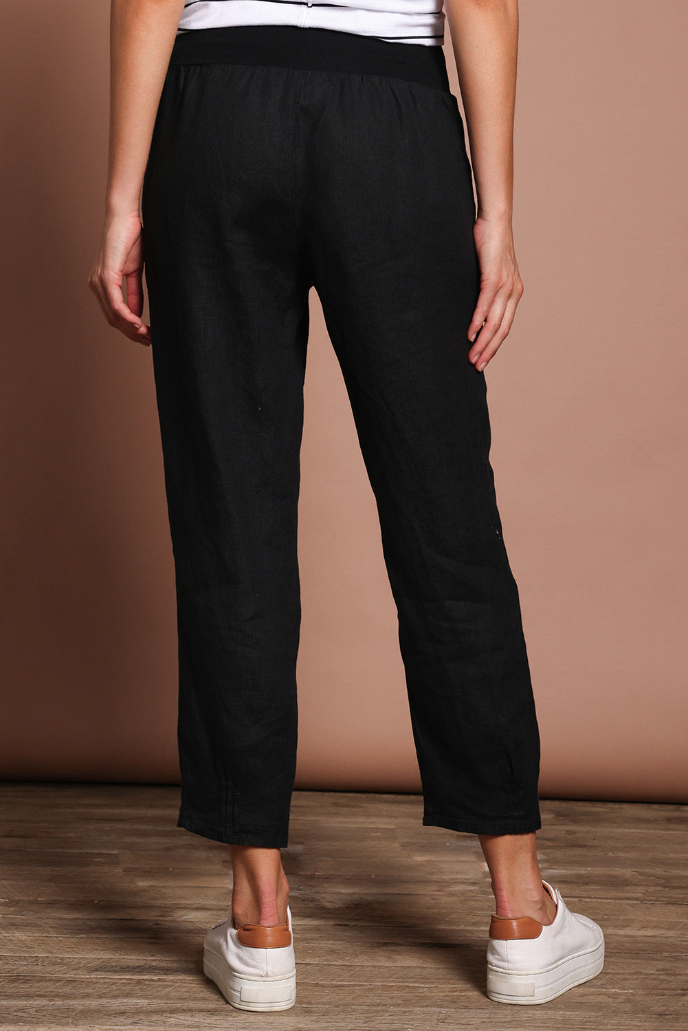 Model Madeline wearing size 10 of the Pull On Linen Pant in colour Black (Black), from the back
