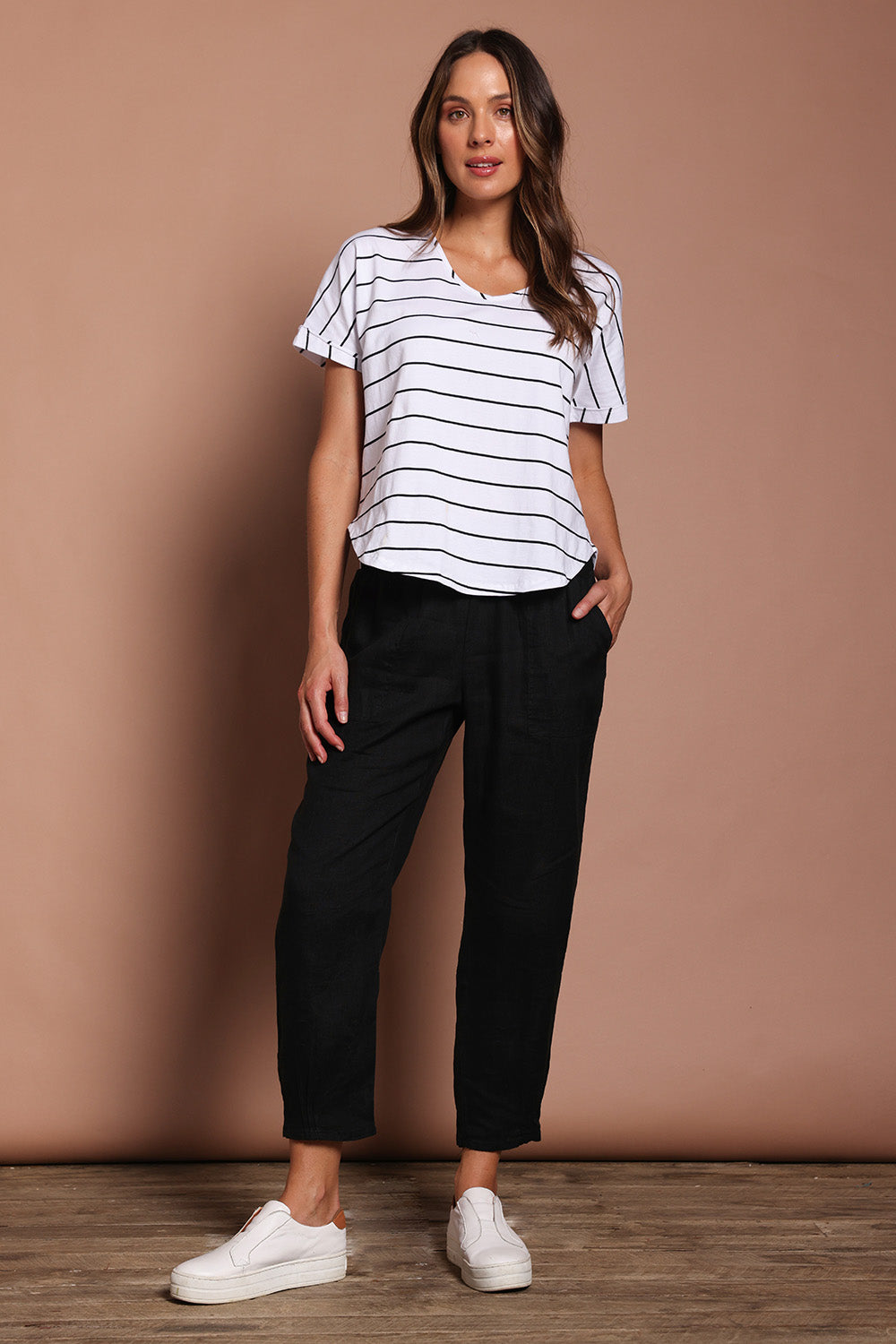 Model Madeline wearing size 10 of the Pull On Linen Pant in colour Black (Black), from the front, showing the whole outfit