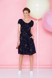 Model Riina wearing size 8 of the Cap Sleeve Dress in colour Navy (Blue), from the front, showing the whole outfit