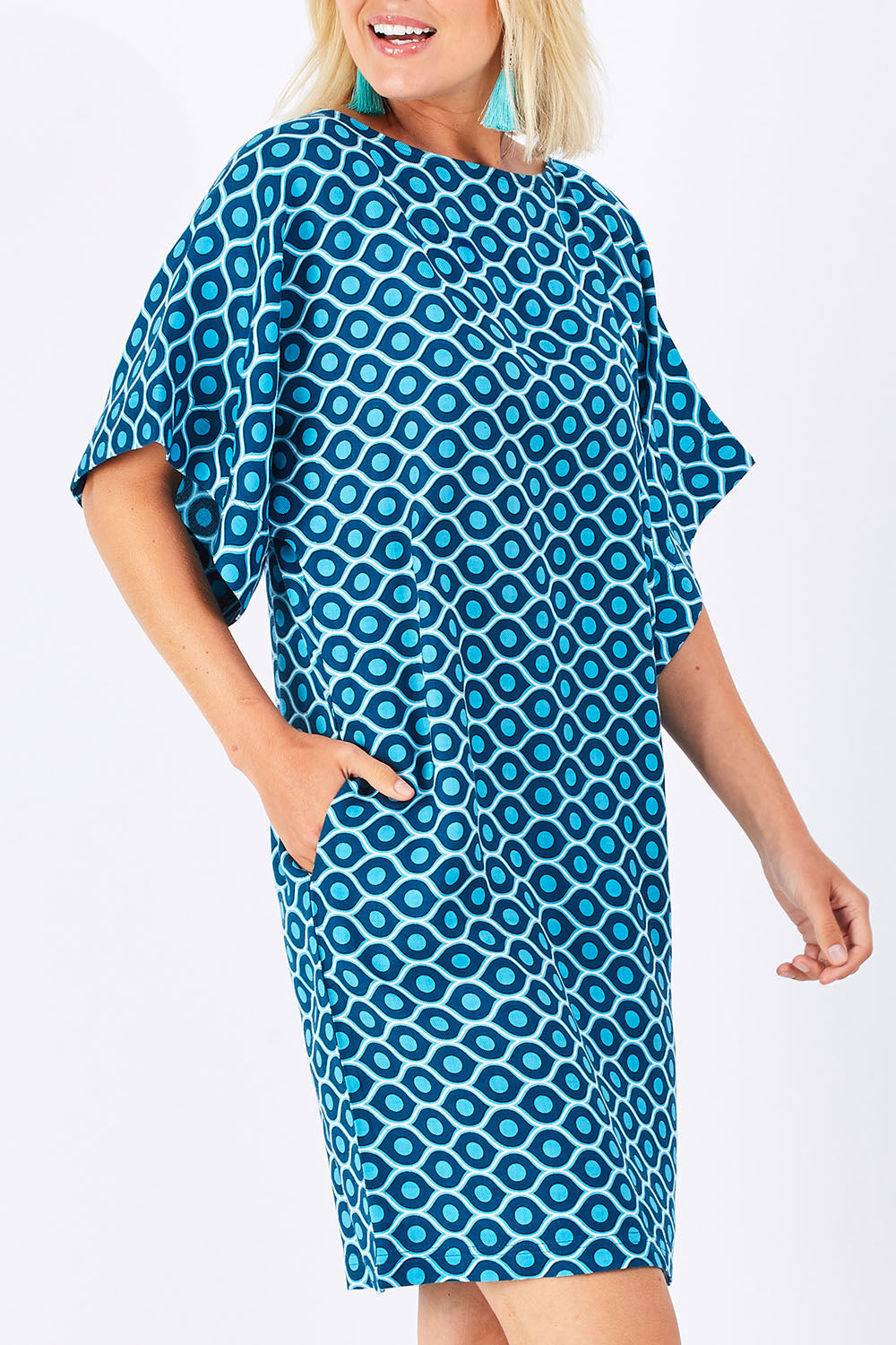 Model Jess wearing size 10 of the Bell Sleeve Tunic Dress in colour TearDrop (Blue), from the front, cropped image