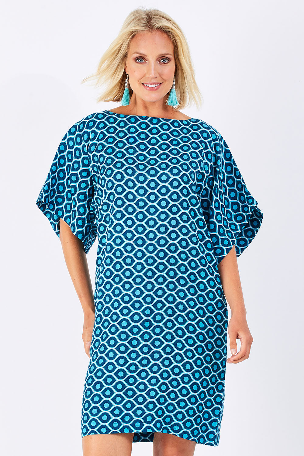 Model Jess wearing size 10 of the Bell Sleeve Tunic Dress in colour TearDrop (Blue), from the front, cropped image