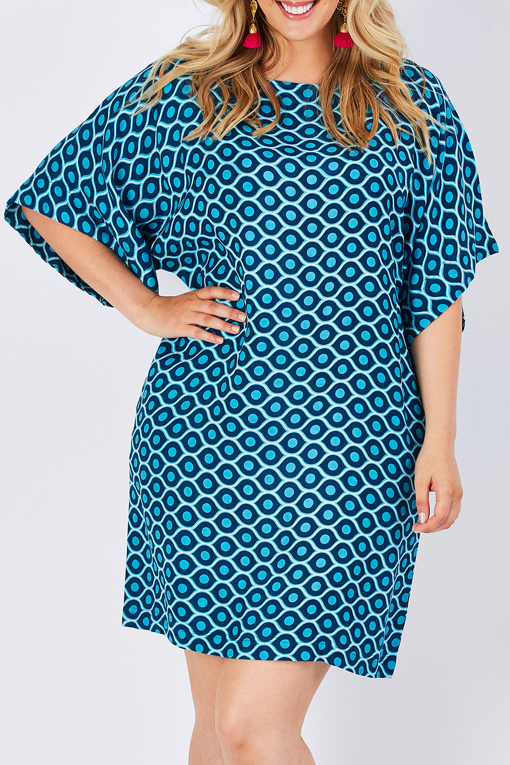 Model Jess wearing size 14 of the Bell Sleeve Tunic Dress in colour TearDrop (Blue), from the front, cropped image