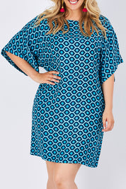 Model Jess wearing size 14 of the Bell Sleeve Tunic Dress in colour TearDrop (Blue), from the front, cropped image