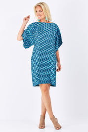 Model Jude wearing size 10 of the Bell Sleeve Tunic Dress in colour TearDrop (Blue), from the front, showing the whole outfit