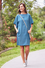 Model Lara wearing size 10 of the Bell Sleeve Tunic Dress in colour TearDrop (Blue), from the front, showing the whole outfit