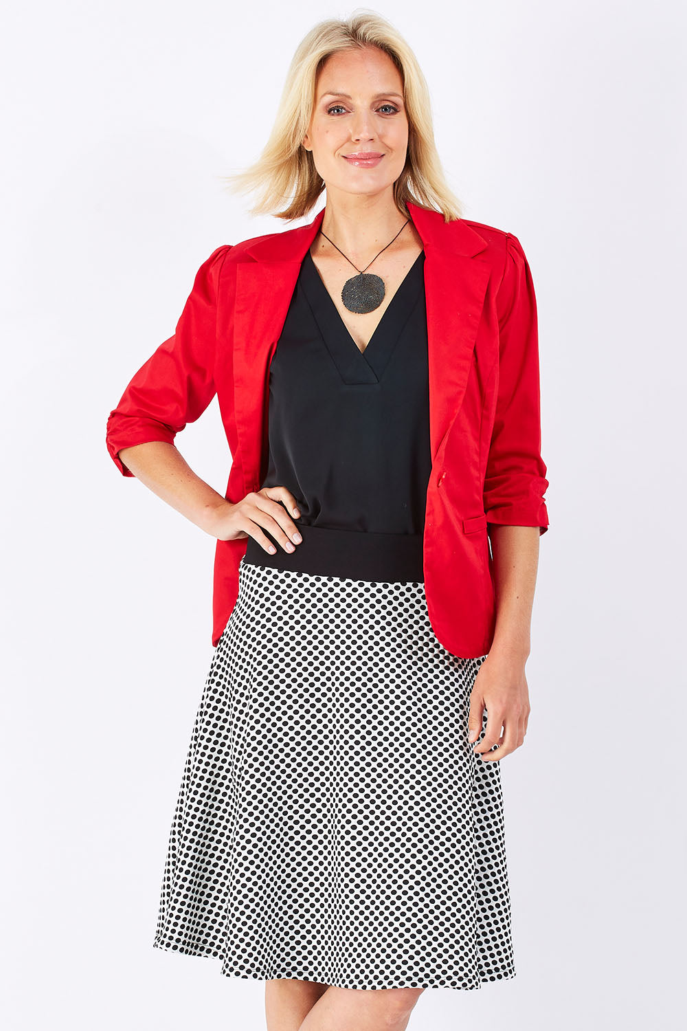 Model Jude wearing size 10 of the Spotted A Line Skirt in colour Spotted (White), from the front, cropped image
