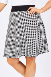 Model Laura wearing size 12 of the Spotted A Line Skirt in colour Spotted (White), from the front, cropped image