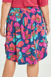 Model Fiona wearing size 16 of the Elastic Waist Curved Hem Skirt in colour Lilly (Blue), from the back