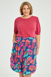 Model Fiona wearing size 16 of the Elastic Waist Curved Hem Skirt in colour Lilly (Blue), from the front, cropped image