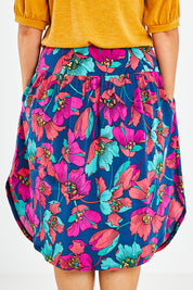 Model Jess wearing size 14 of the Elastic Waist Curved Hem Skirt in colour Lilly (Blue), from the back