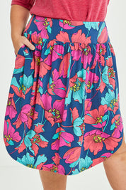Model Lauren wearing size 16 of the Elastic Waist Curved Hem Skirt in colour Lilly (Blue), from the front, cropped image