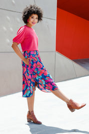 Model Olivia wearing size 10 of the Elastic Waist Curved Hem Skirt in colour Lilly (Blue), from the front, showing the whole outfit