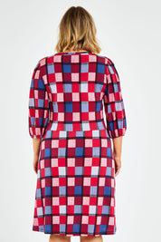 Model Jess wearing size 14 of the Gathered Waist Faux Wrap Dress in colour Checkered (Red), from the back