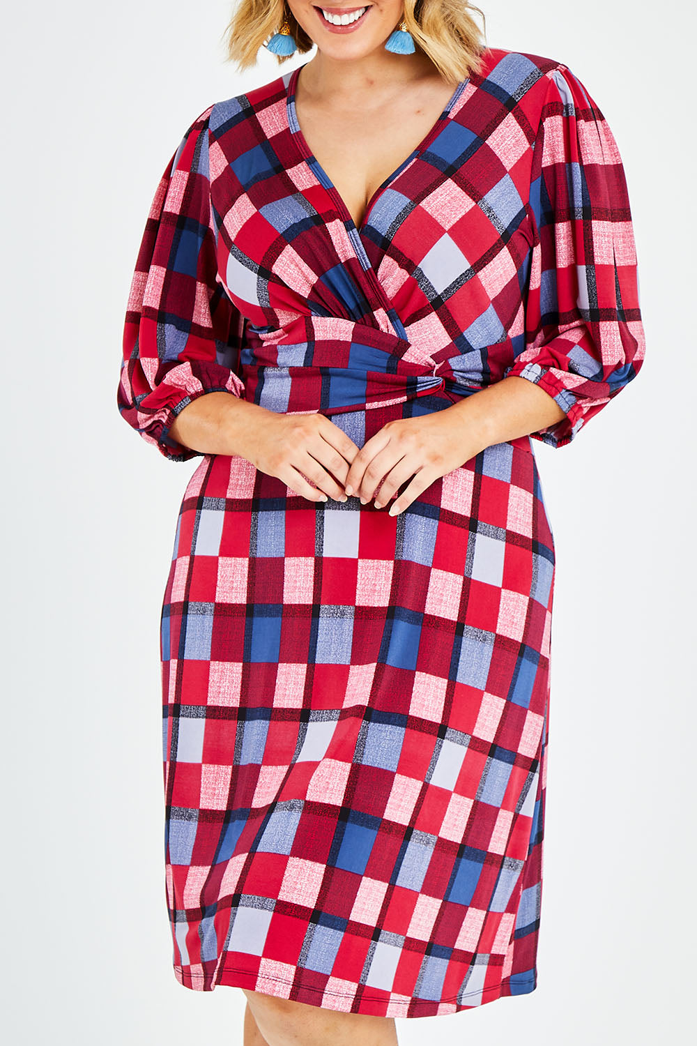 Model Jess wearing size 14 of the Gathered Waist Faux Wrap Dress in colour Checkered (Red), from the front, cropped image