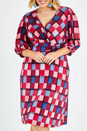 Model Jess wearing size 14 of the Gathered Waist Faux Wrap Dress in colour Checkered (Red), from the front, cropped image