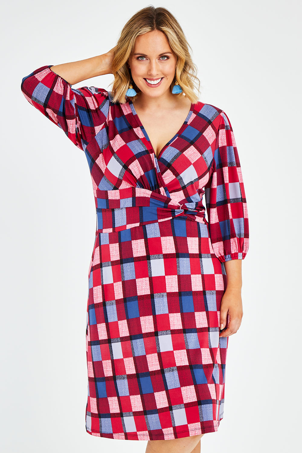 Model Jess wearing size 14 of the Gathered Waist Faux Wrap Dress in colour Checkered (Red), from the front, cropped image