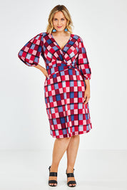 Model Jess wearing size 14 of the Gathered Waist Faux Wrap Dress in colour Checkered (Red), from the front, showing the whole outfit