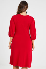 Model Laura wearing size 14 of the Gathered Waist Faux Wrap Dress in colour Flame (Red), from the back