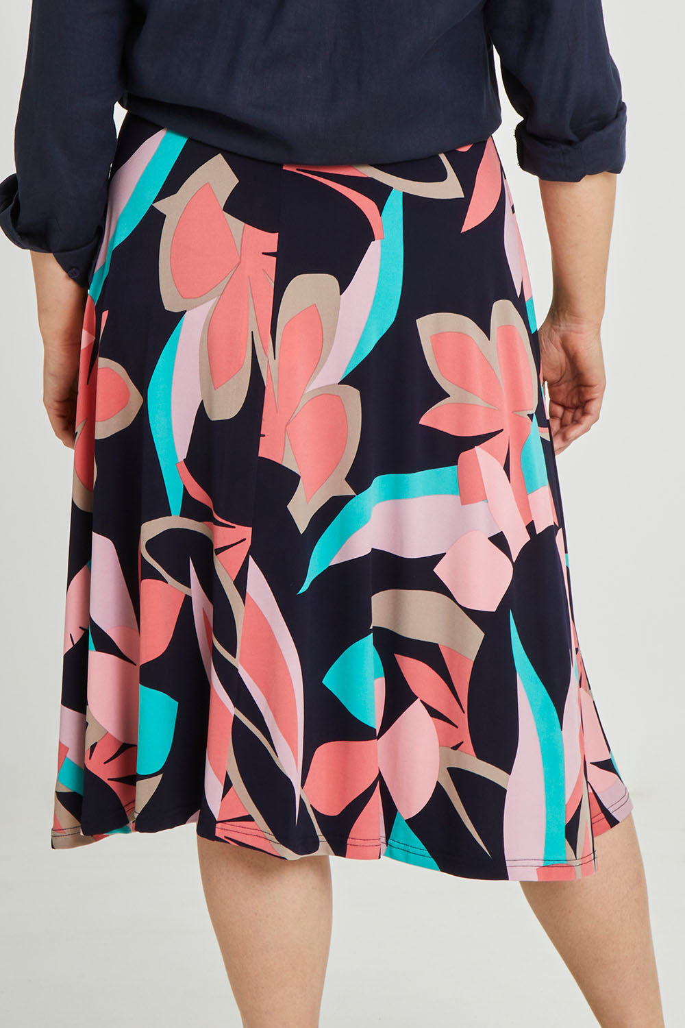 Model Keeara wearing size 16 of the Printed Calf Length Full Skirt in colour Pastels (Blue), from the back