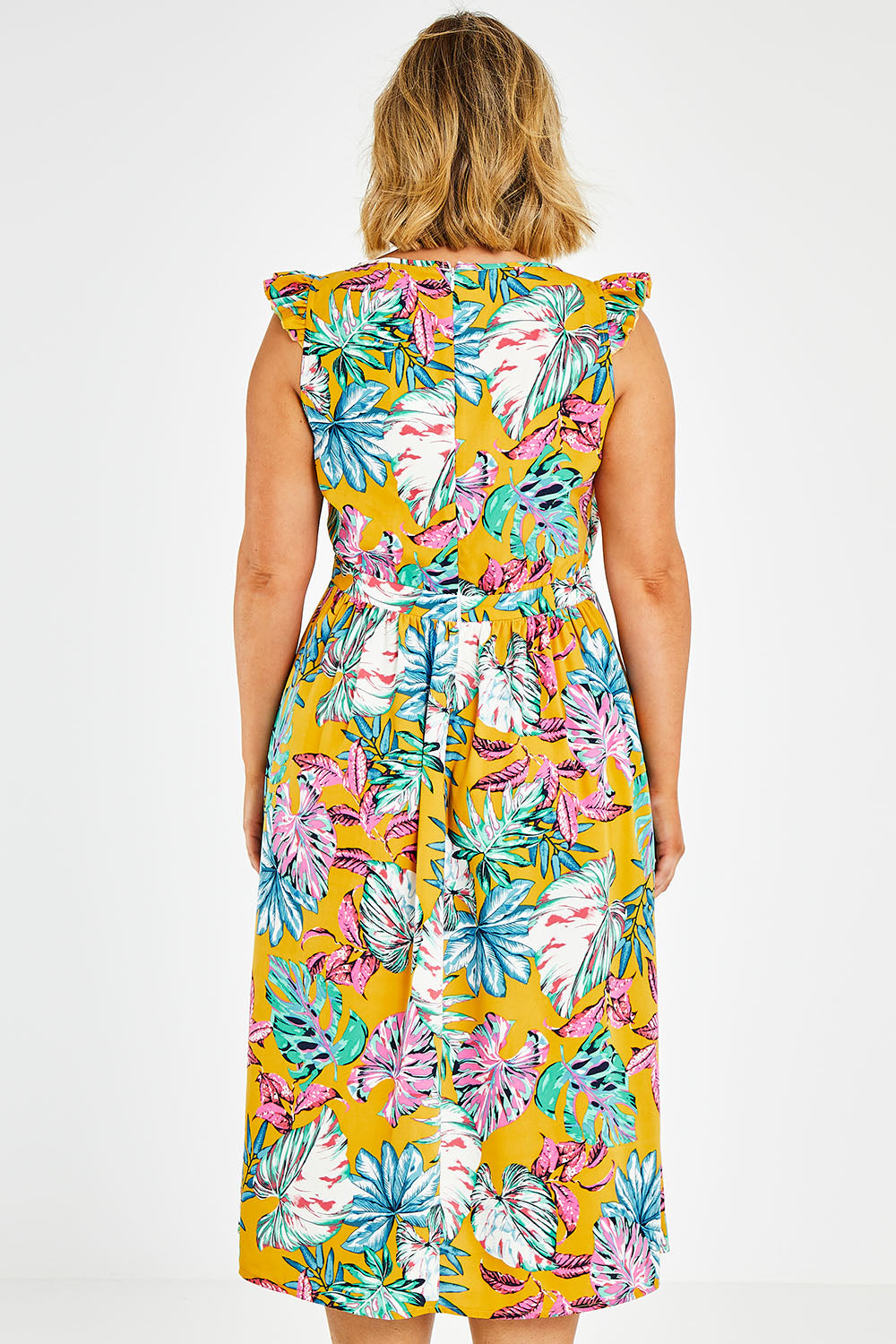 Model Jess wearing size 14 of the V Neck Gathered Sleeve Dress in colour Garden, from the back