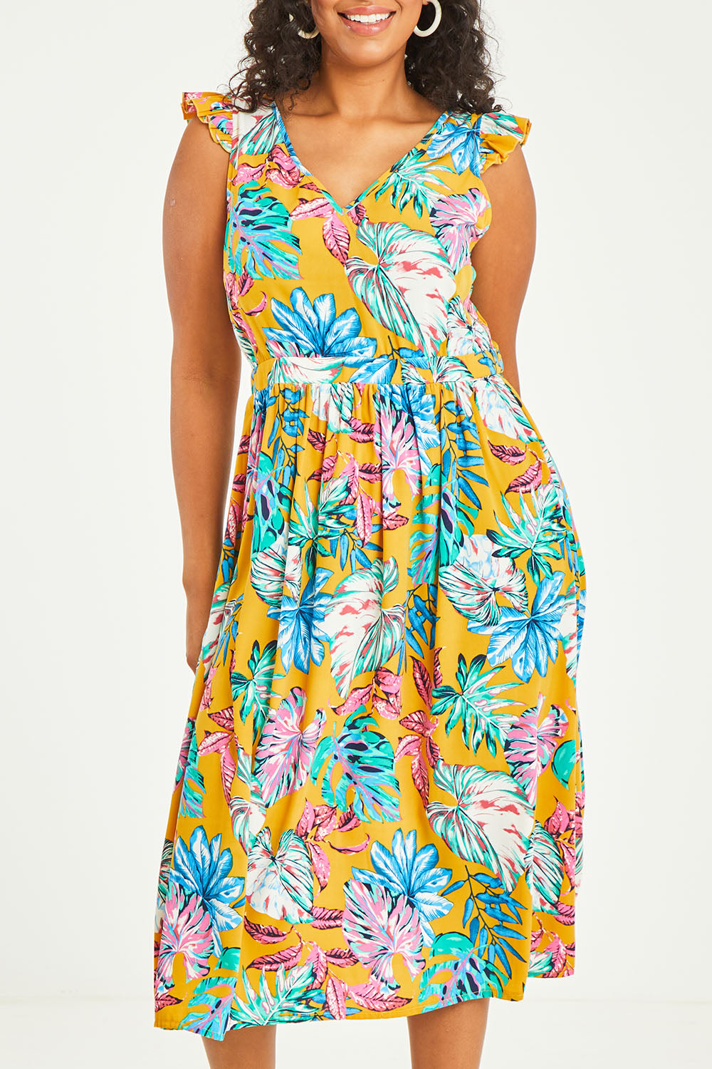 Model Noli wearing size 14 of the V Neck Gathered Sleeve Dress in colour Garden, from the front, cropped image