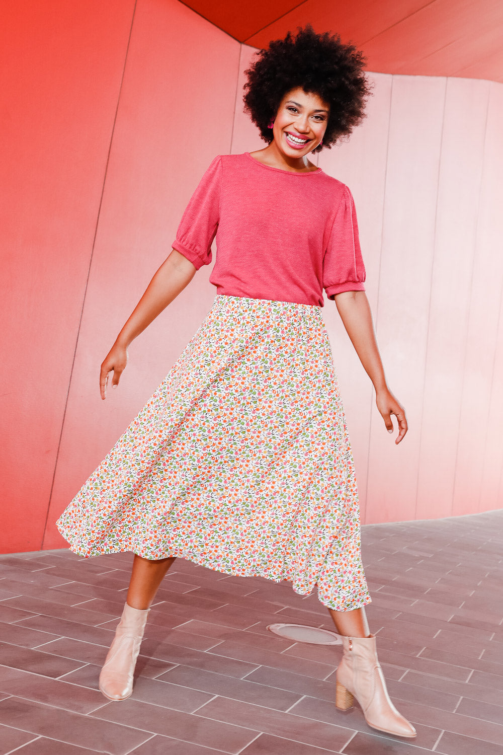 Model Olivia wearing size 10 of the Calf Length Full Skirt in colour Posy (White), from the front, showing the whole outfit