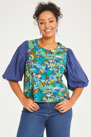 Model Noli wearing size 14 of the Printed Full Sleeve Top in colour Jungle (Blue), from the front, cropped image