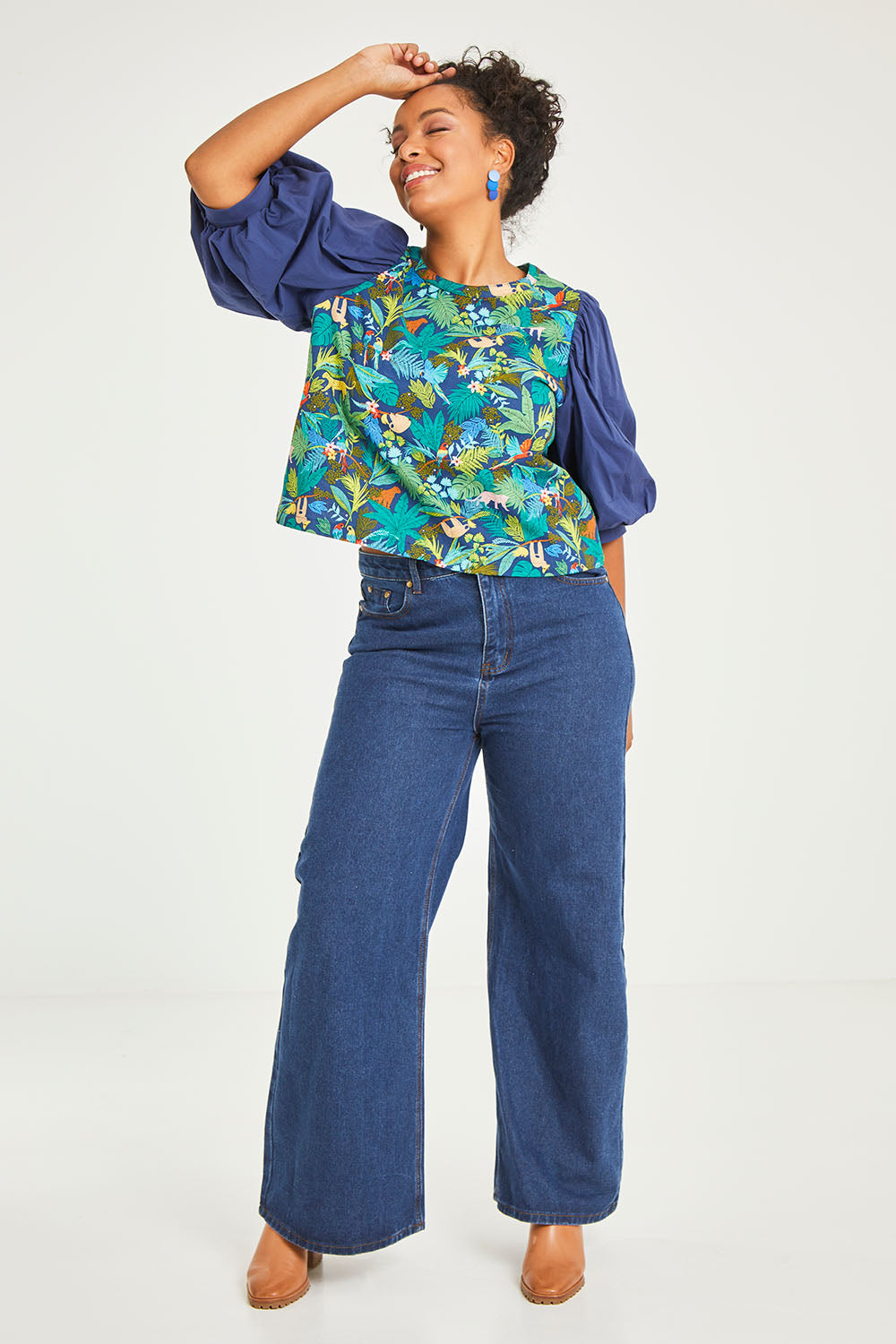 Model Noli wearing size 14 of the Printed Full Sleeve Top in colour Jungle (Blue), from the front, showing the whole outfit