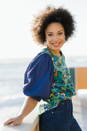 Model Olivia wearing size 10 of the Printed Full Sleeve Top in colour Jungle (Blue), from the front, showing the whole outfit