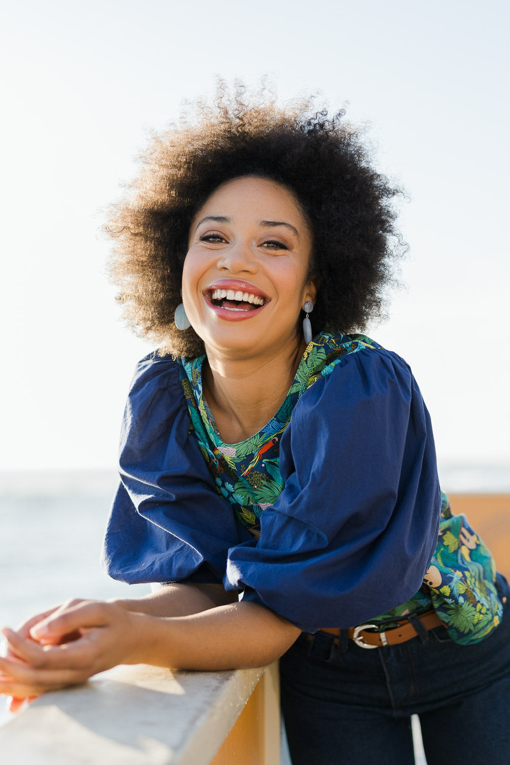 Model Olivia wearing size 10 of the Printed Full Sleeve Top in colour Jungle (Blue), from the front, showing the whole outfit