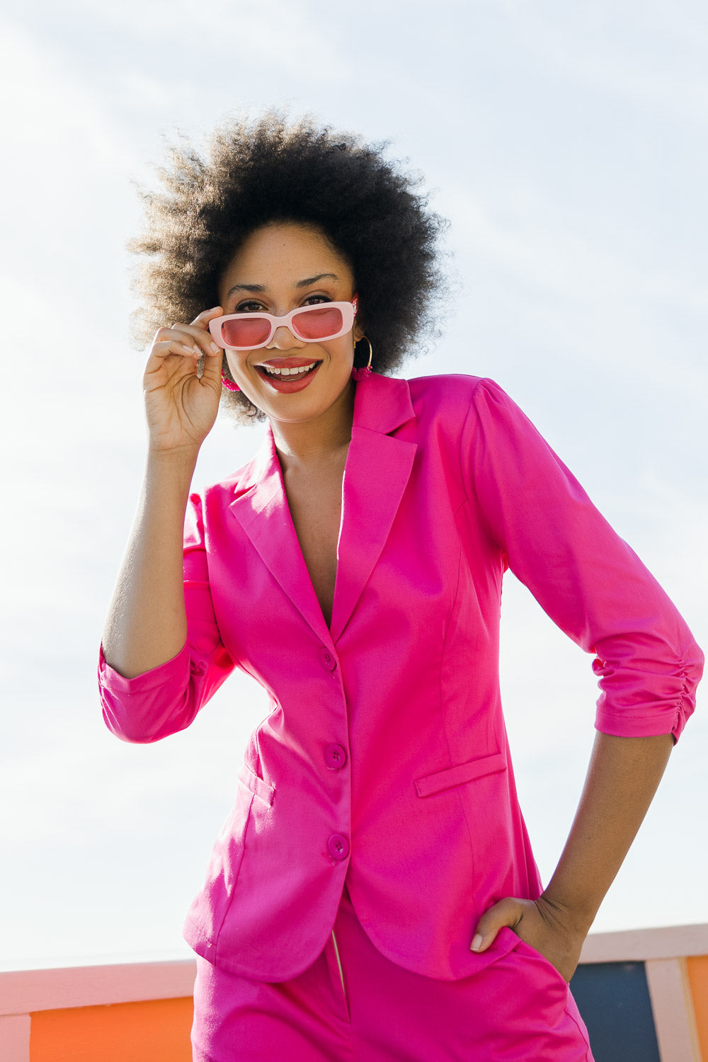 Model Olivia wearing size 10 of the Buttoned Blazer in colour Hotpink (Pink), from the front, showing the whole outfit