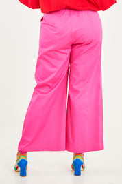 Model Noli wearing size 14 of the Wide Leg Pant in colour Hotpink (Pink), from the back