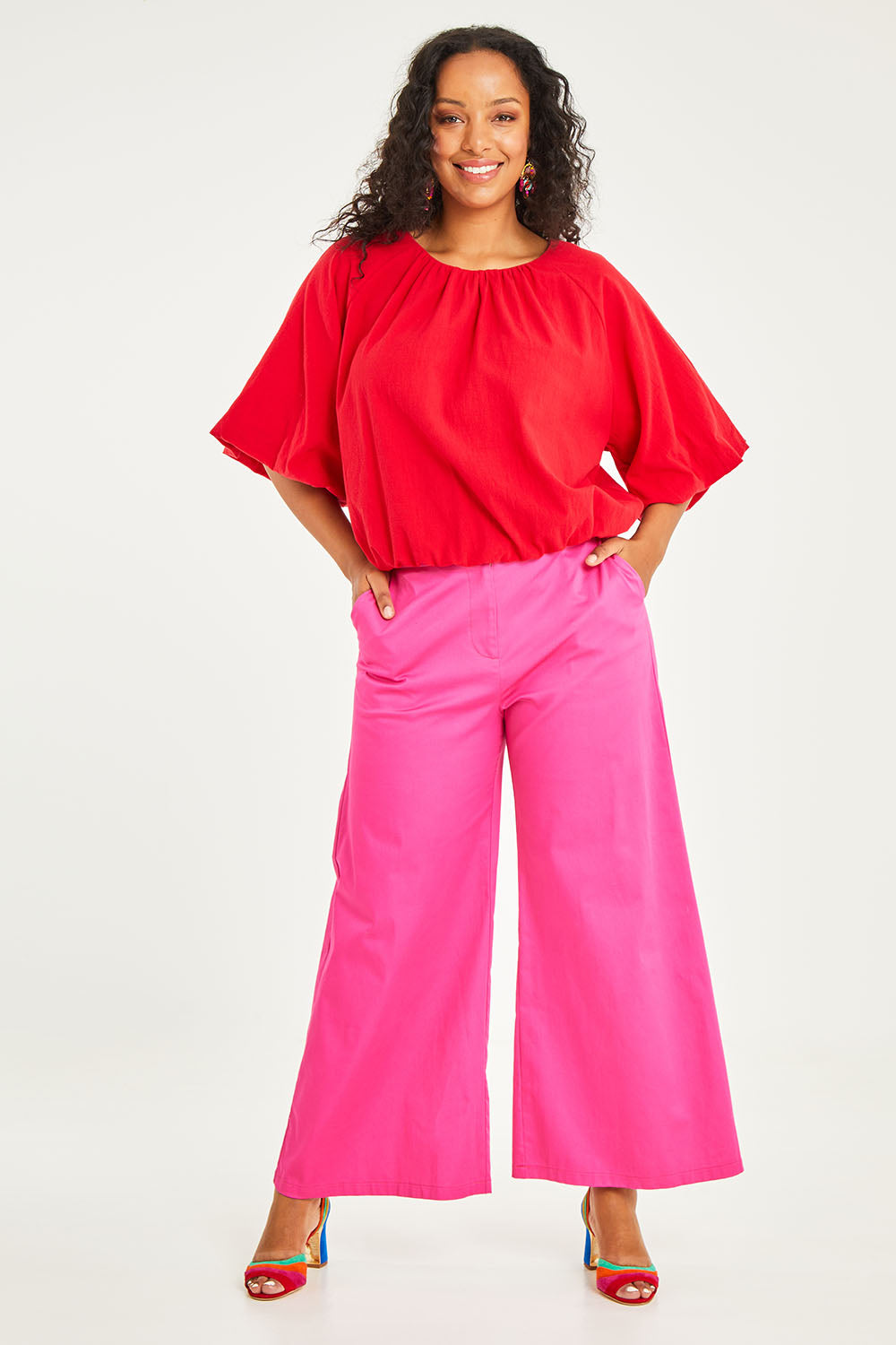Model Noli wearing size 14 of the Wide Leg Pant in colour Hotpink (Pink), from the front, showing the whole outfit