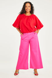 Model Noli wearing size 14 of the Wide Leg Pant in colour Hotpink (Pink), from the front, showing the whole outfit