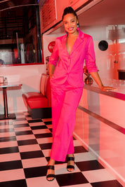 Model Olivia wearing size 10 of the Wide Leg Pant in colour Hotpink (Pink), from the front, showing the whole outfit